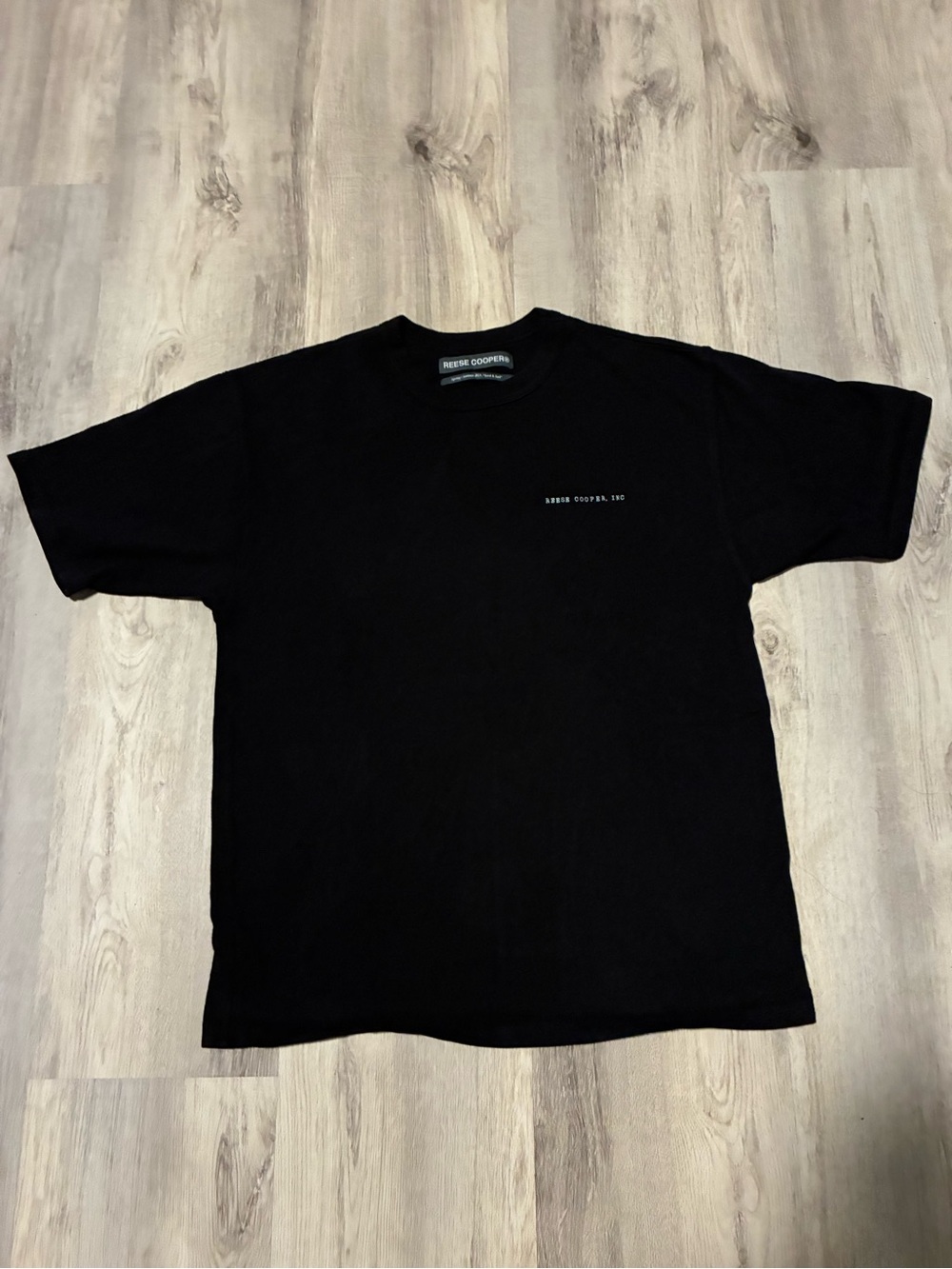Reese Cooper Black Crewneck Tee with Small White Chest Text